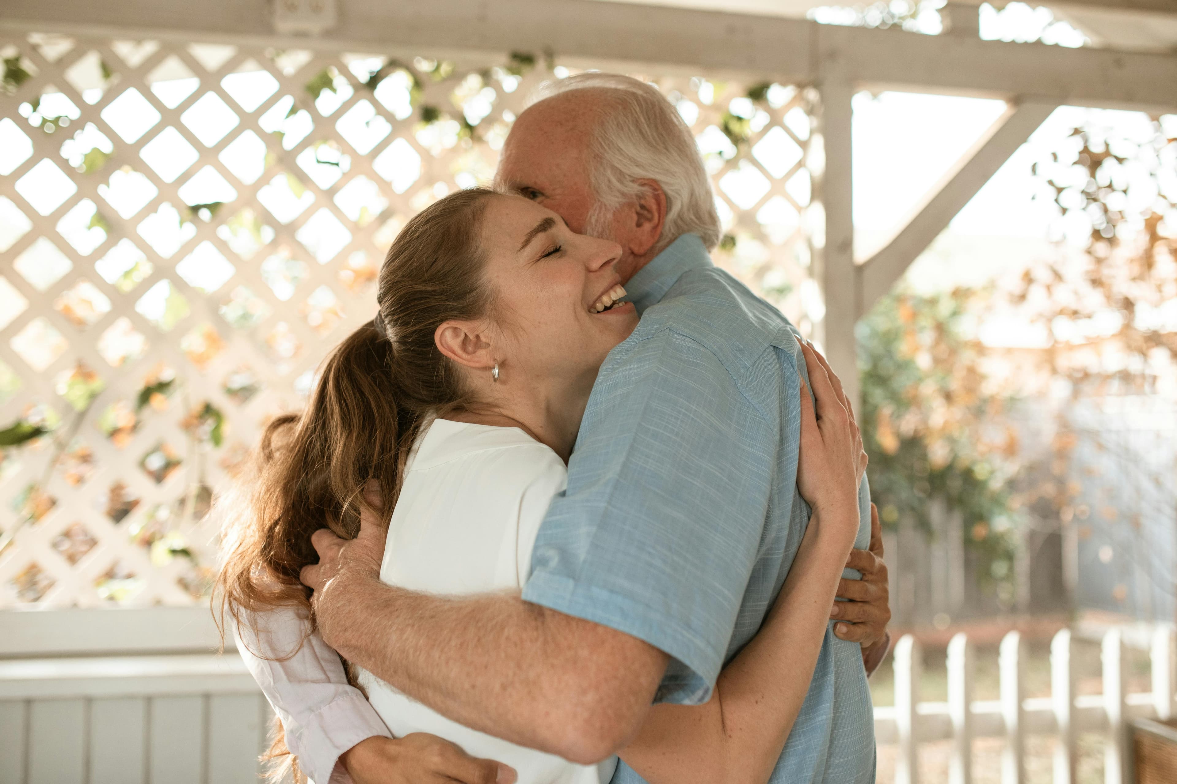 Adult daughter hugging her father